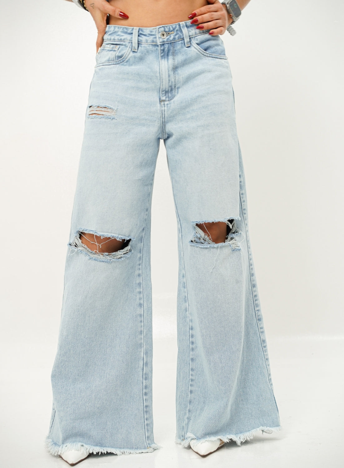 Woman wearing ripped light blue denim alien jeans