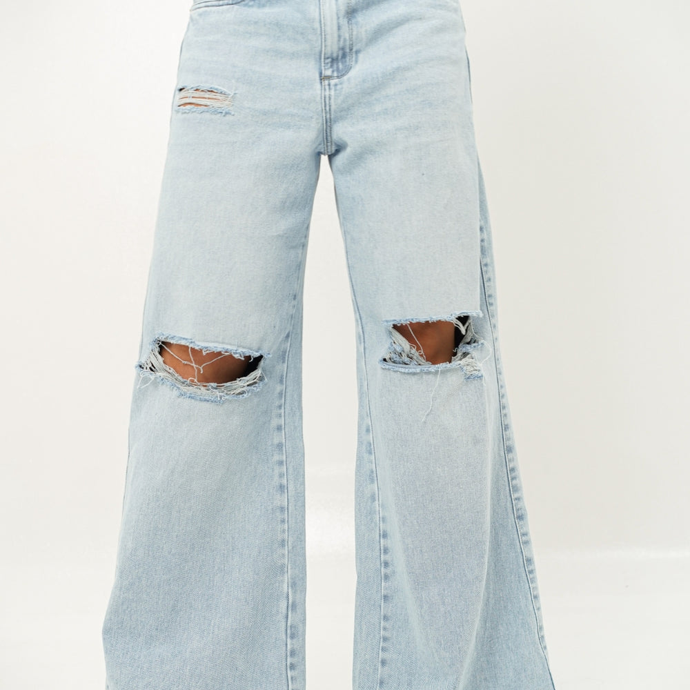 
                      
                        Woman wearing ripped light blue denim alien jeans 
                      
                    