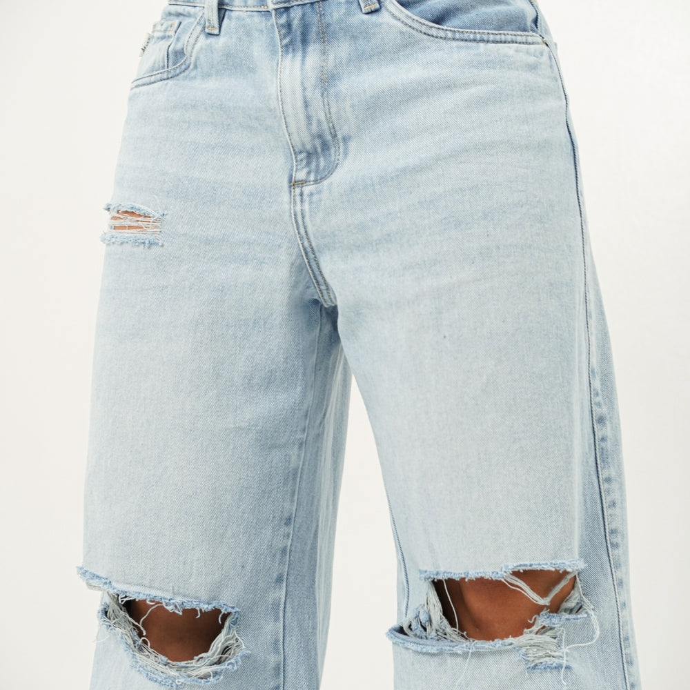 
                      
                        Woman wearing ripped light blue denim alien jeans 
                      
                    